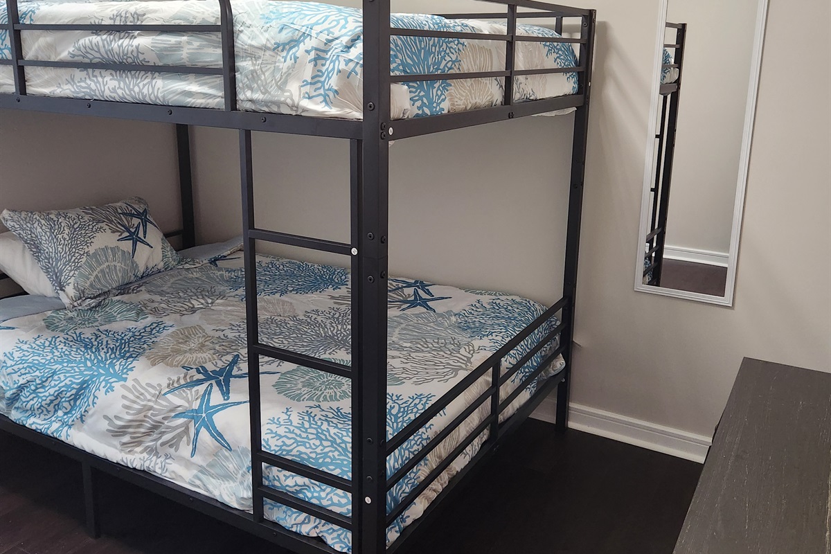Designed with simplicity and functionality in mind, this minimalist bunk room is great for kids, teens, or friends.