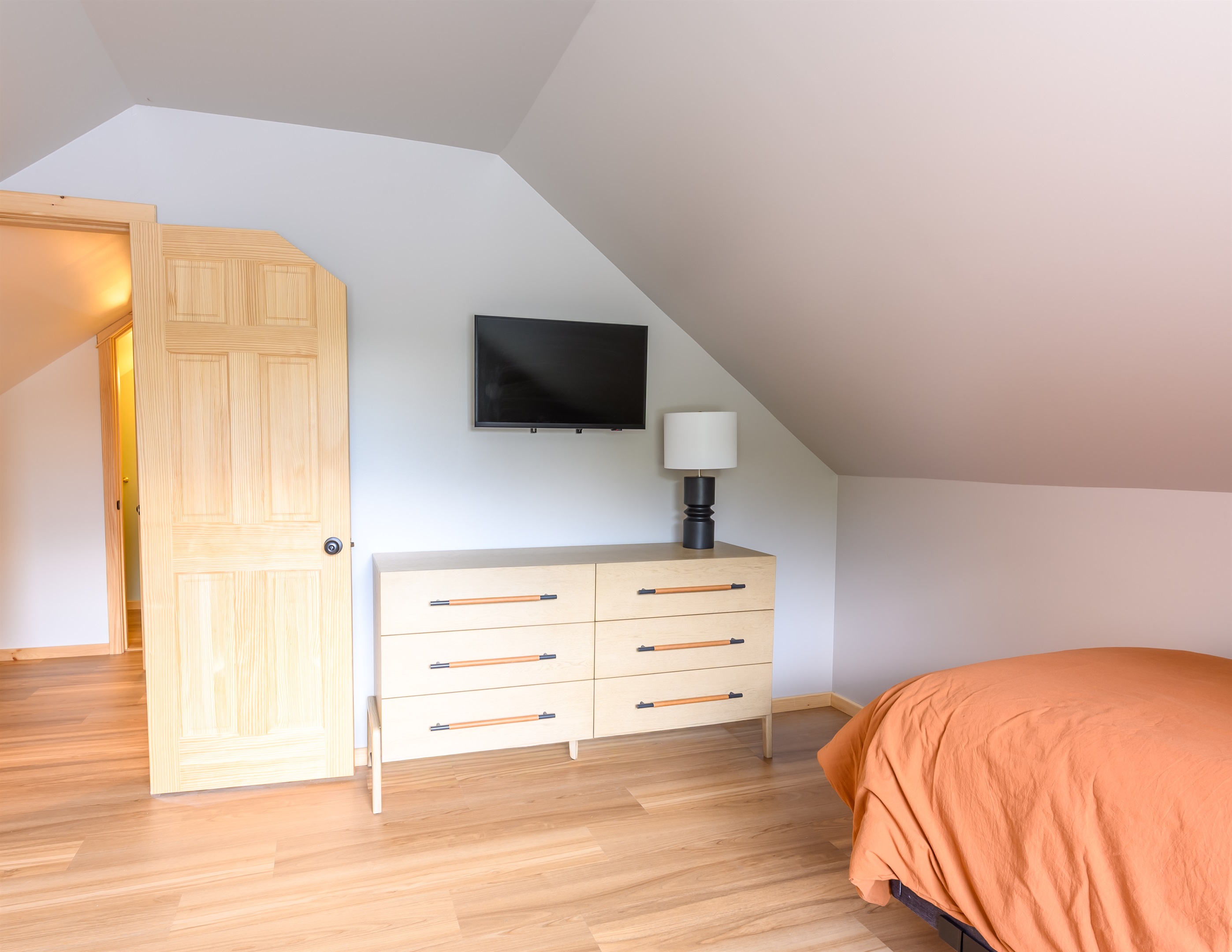 a large dresser and a 32 inch smart tv.