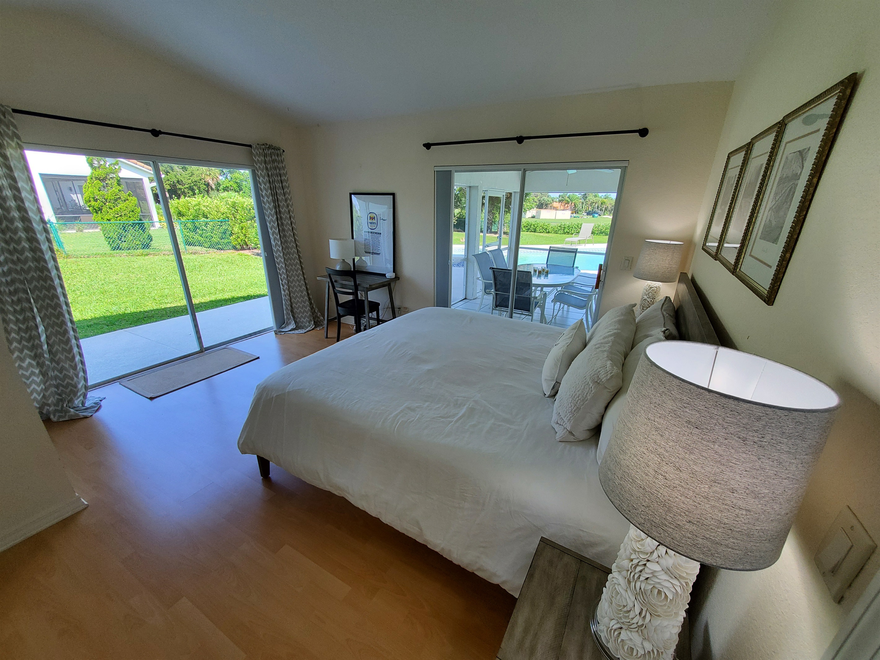 2nd King bedroom with access to lanai and yard; desk and chair