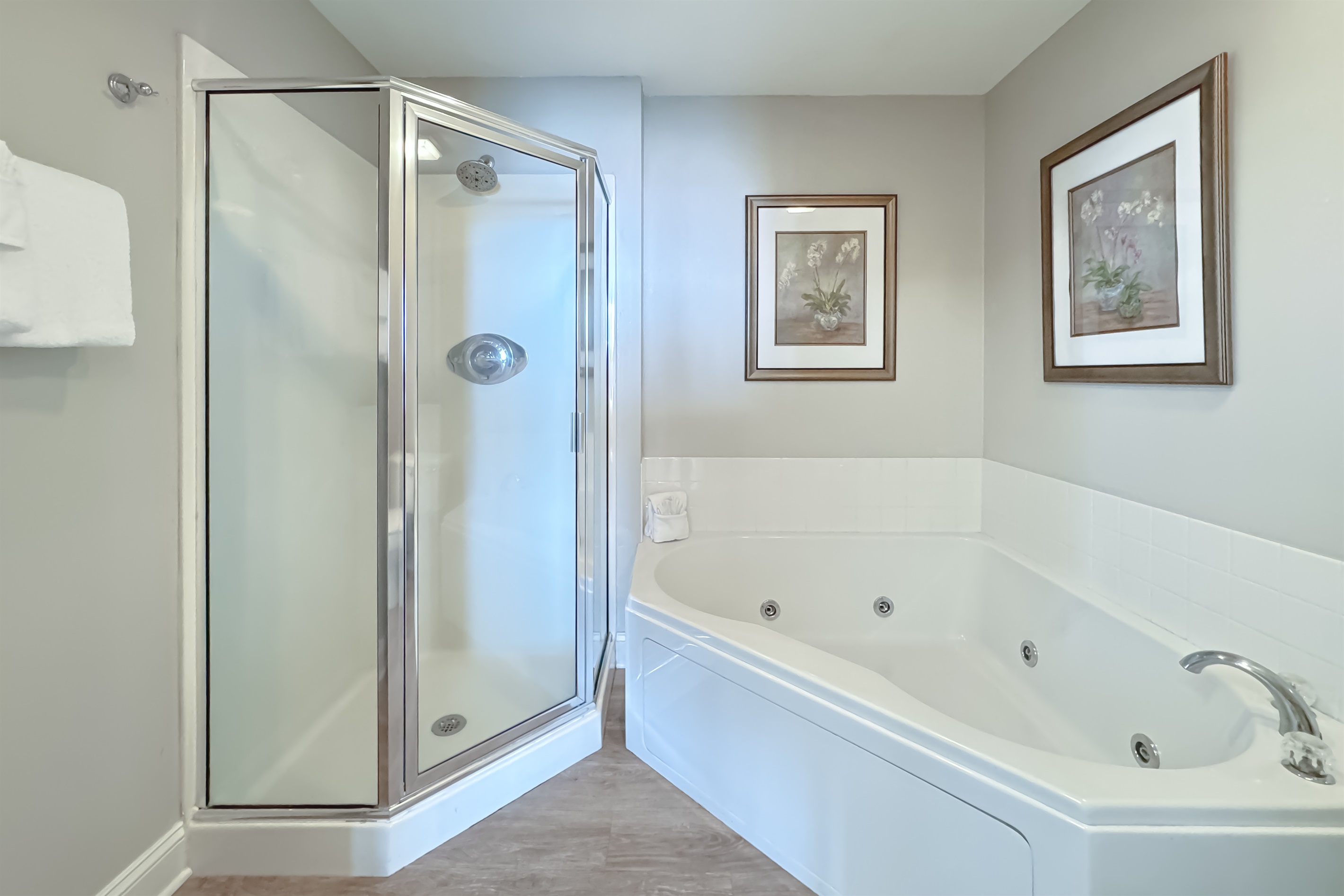 Modern and clean design. With ample lighting, a glass-enclosed walk-in shower, jetted tub, and fresh coastal decor, this bathroom provides all the necessary comforts for a seamless stay.