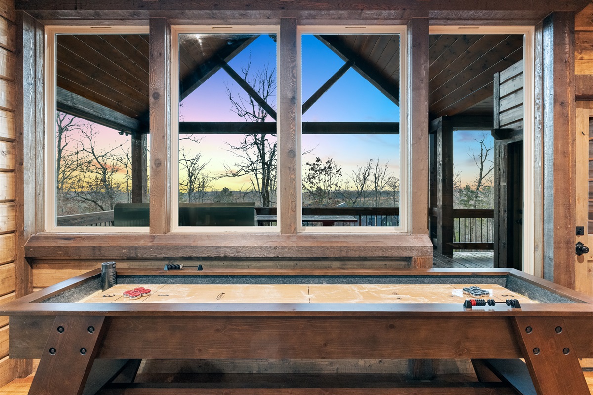 Indoor shuffleboard table with scenic mountain views for endless entertainment