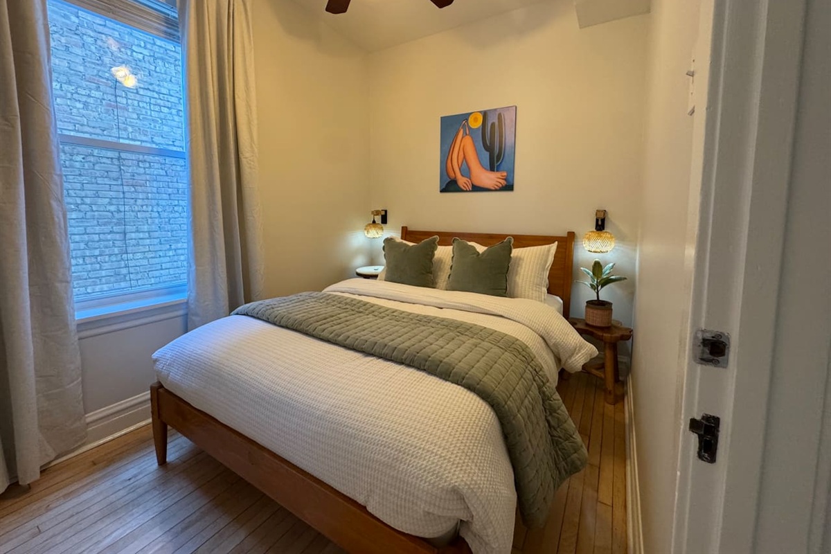 Comfortable bedroom with soft linens and natural light.