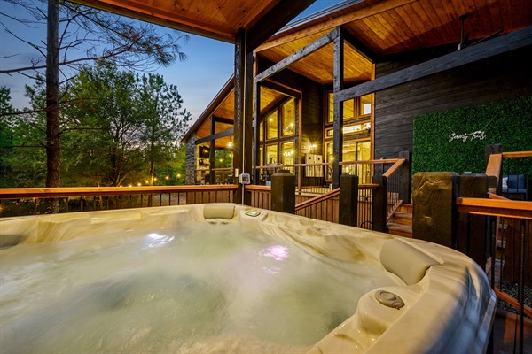 Sunset soak: Private hot tub with breathtaking forest views.