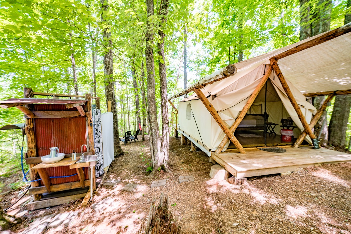 Tent with its attached shower and sink area