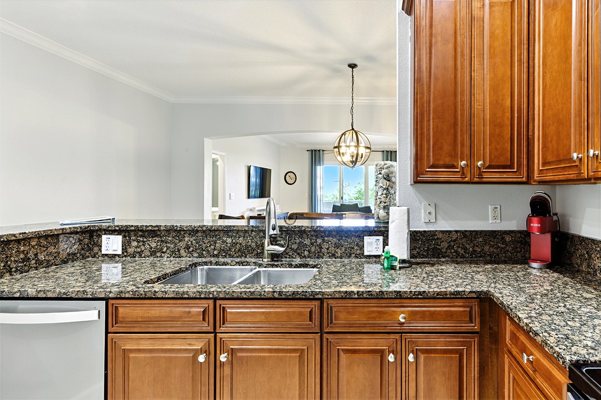 ☕🌊 Morning coffee with a view—this granite breakfast bar opens right into the living area, so you can sip a fresh Keurig brew while the whole space feels bright, open, and vacation-ready. ✨🏡
