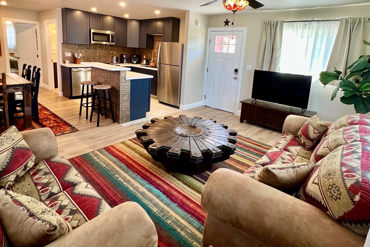 Relax in the spacious, open-concept living room, flowing right into a modern, fully-equipped kitchen. Perfect for gathering!