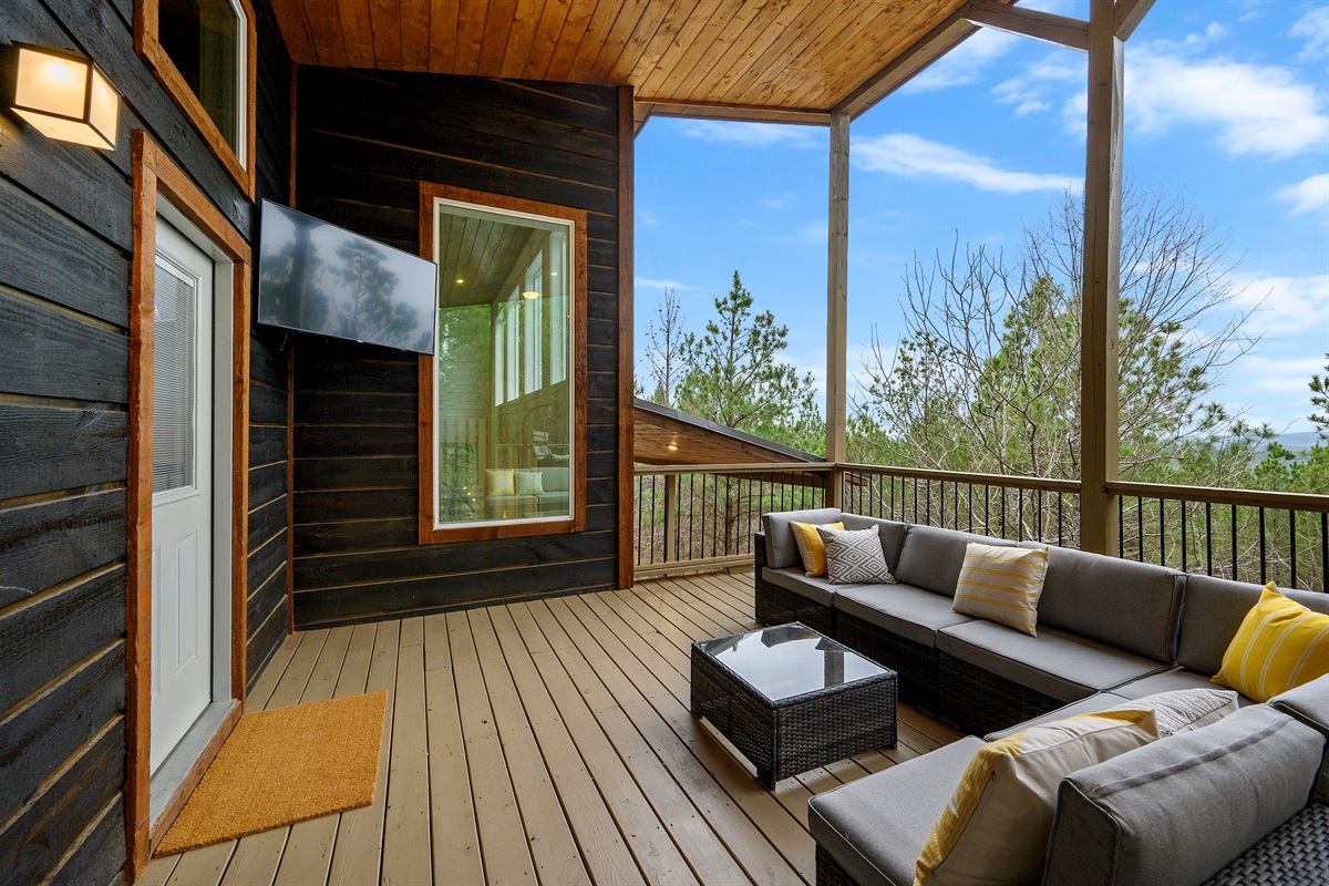 A comfortable outdoor patio with seating and a TV — perfect for relaxing, watching, and enjoying the fresh air