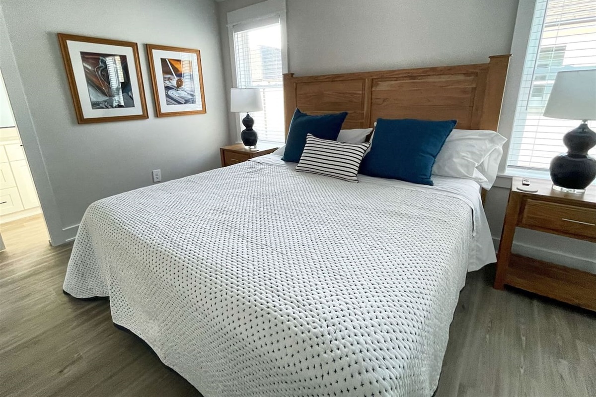 This spacious guest bedroom features a plush king-size bed and cozy coastal décor.