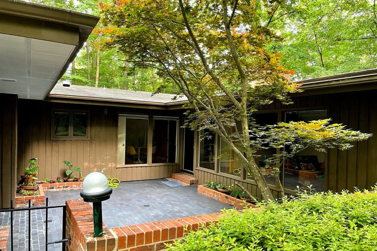 A true mid-century modernist home tucked into an acre of woods &mdash; architectural on the outside, warm and lived-in within.