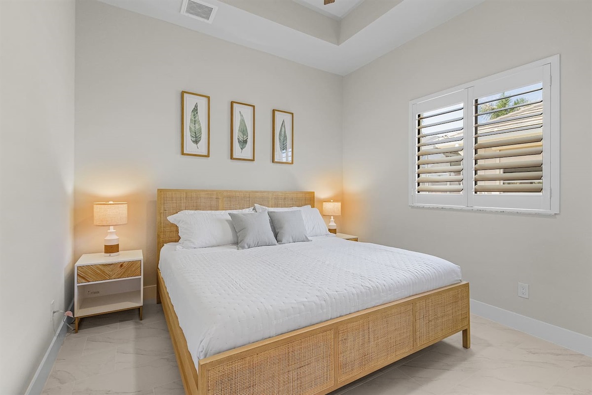 Experience serenity in the 3rd guest bedroom, adorned with coastal décor and a plush king-size bed!