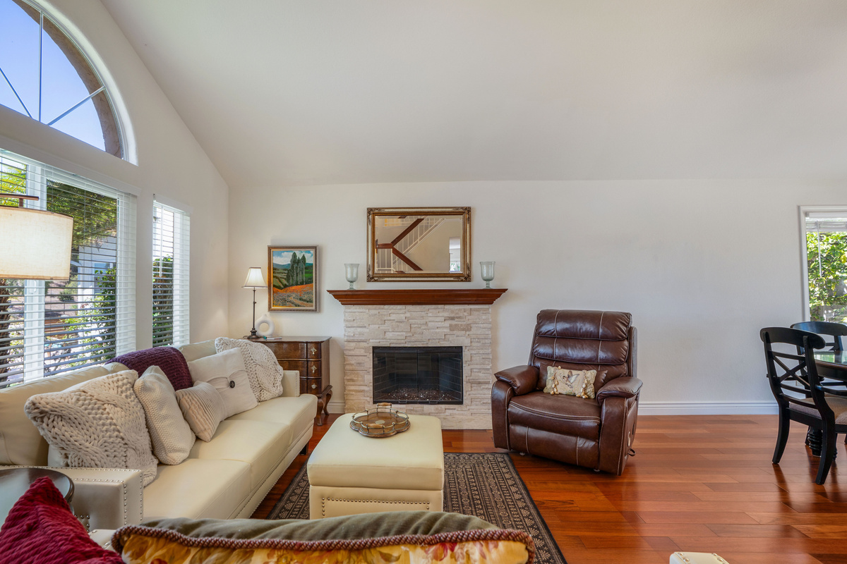 Welcoming Living Room with Fireplace, Two Sofas, Massage Recliner