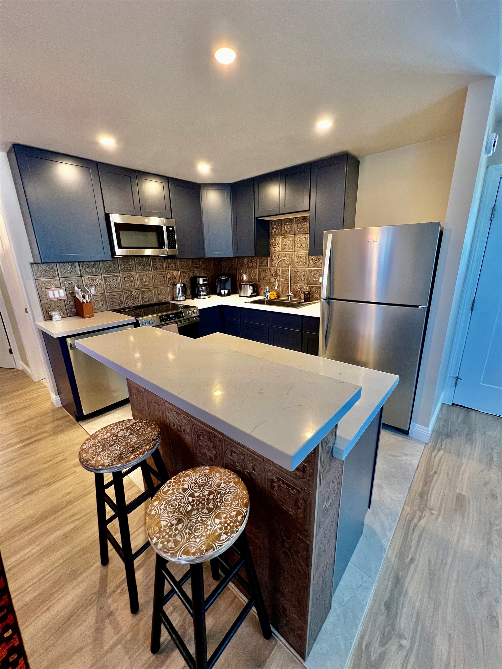 Whip up a meal in the fully-equipped modern kitchen, featuring stainless steel appliances and a stylish breakfast bar with seating for two.