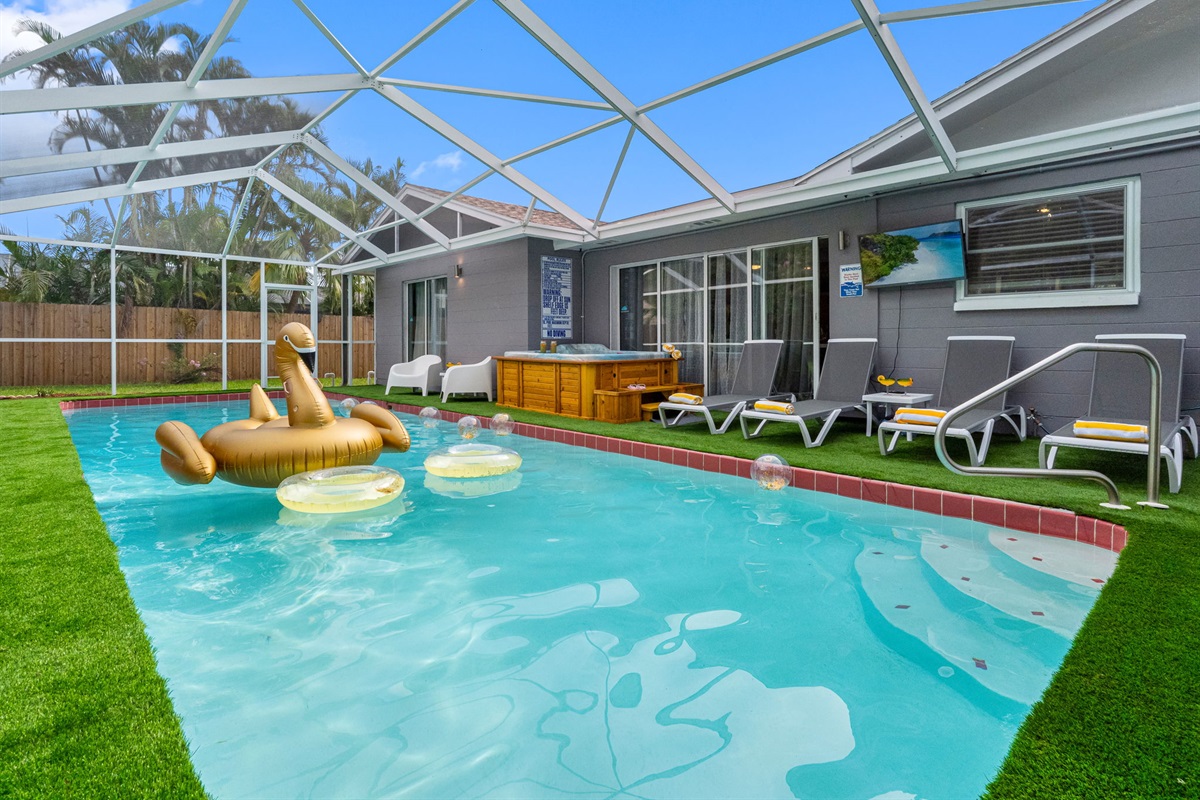 Lounge in style beneath a screened lanai, with crystal-clear waters, comfy chairs, and a golden float that screams vacation.