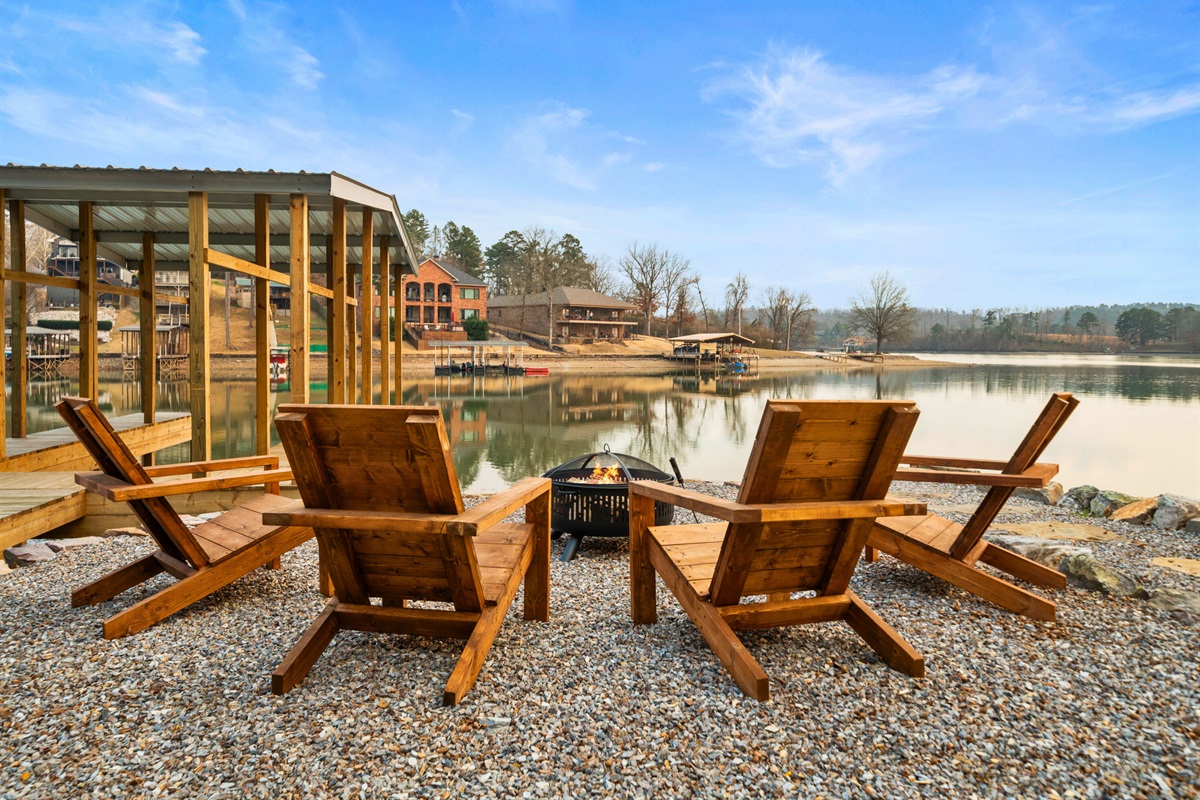 Adirondack chairs arranged around the firepit offer a relaxing place to enjoy the glow of the fire and the quiet of the water.