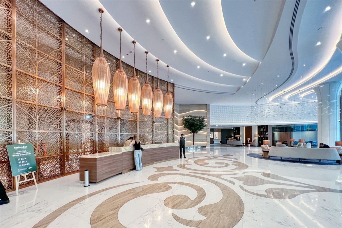 Step into a grand lobby with elegant d&eacute;cor, hotel-style luxury, artistic lighting, and spacious seating&mdash;offering a warm, sophisticated welcome.