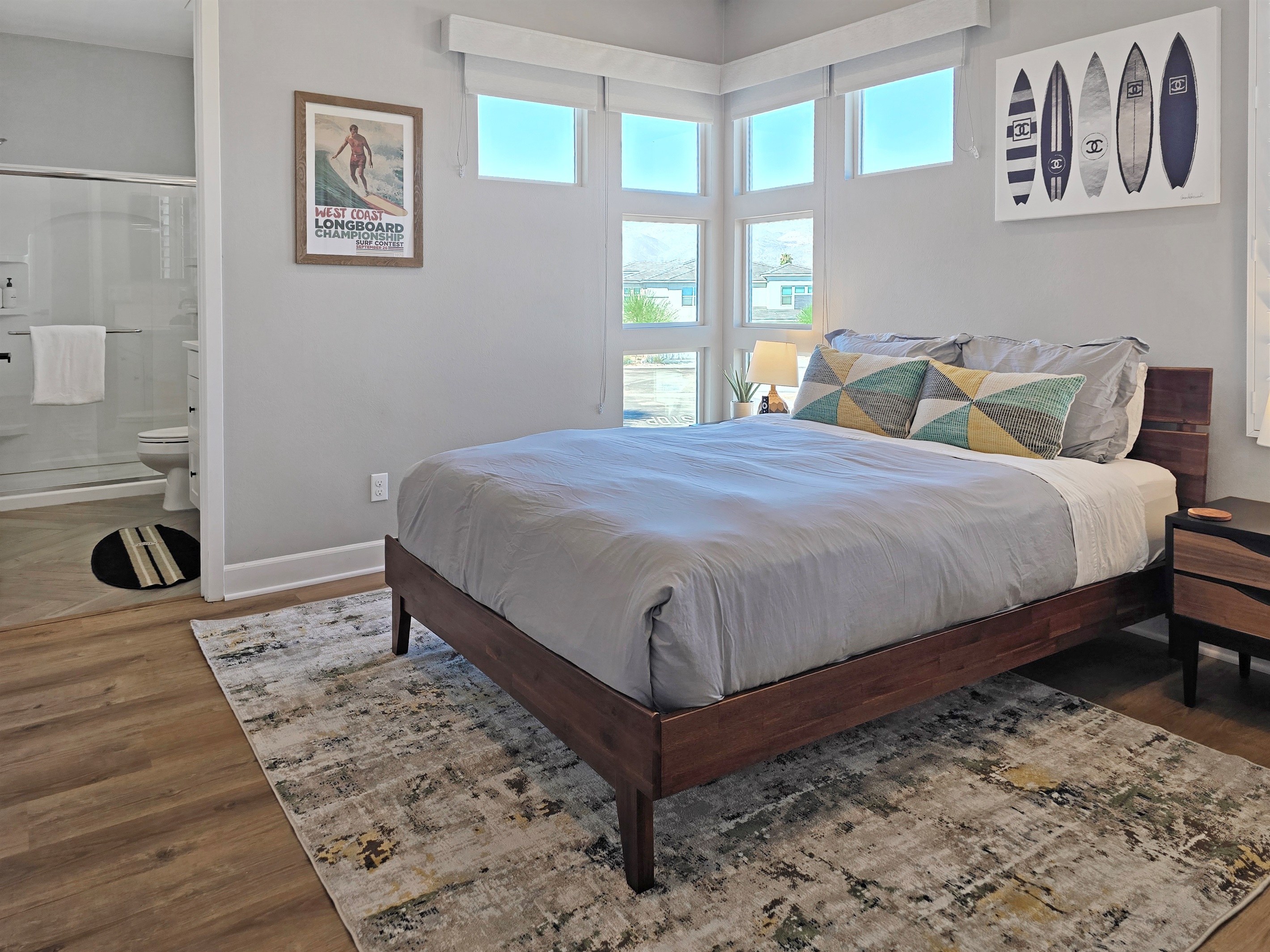 Bedroom #3 features a queen-sized bed, lake views, ceiling fan, smart TV, closet and an ensuite bathroom with walk-in shower. (Sleeps 2)