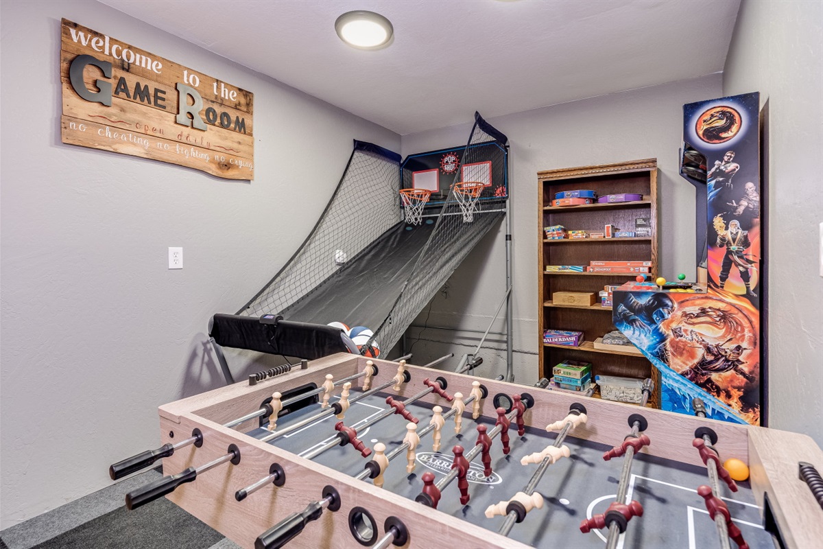 Discover the perfect game room equipped with an arcade basketball game, foosball table, board games, and puzzles. It's a fun-filled space for all ages.