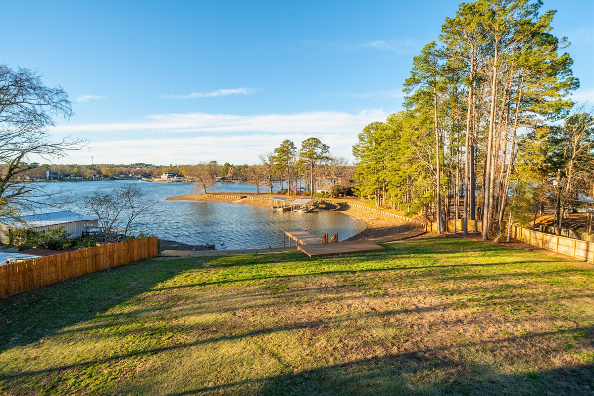 Lake views framed by trees create a peaceful backdrop just outside the home.