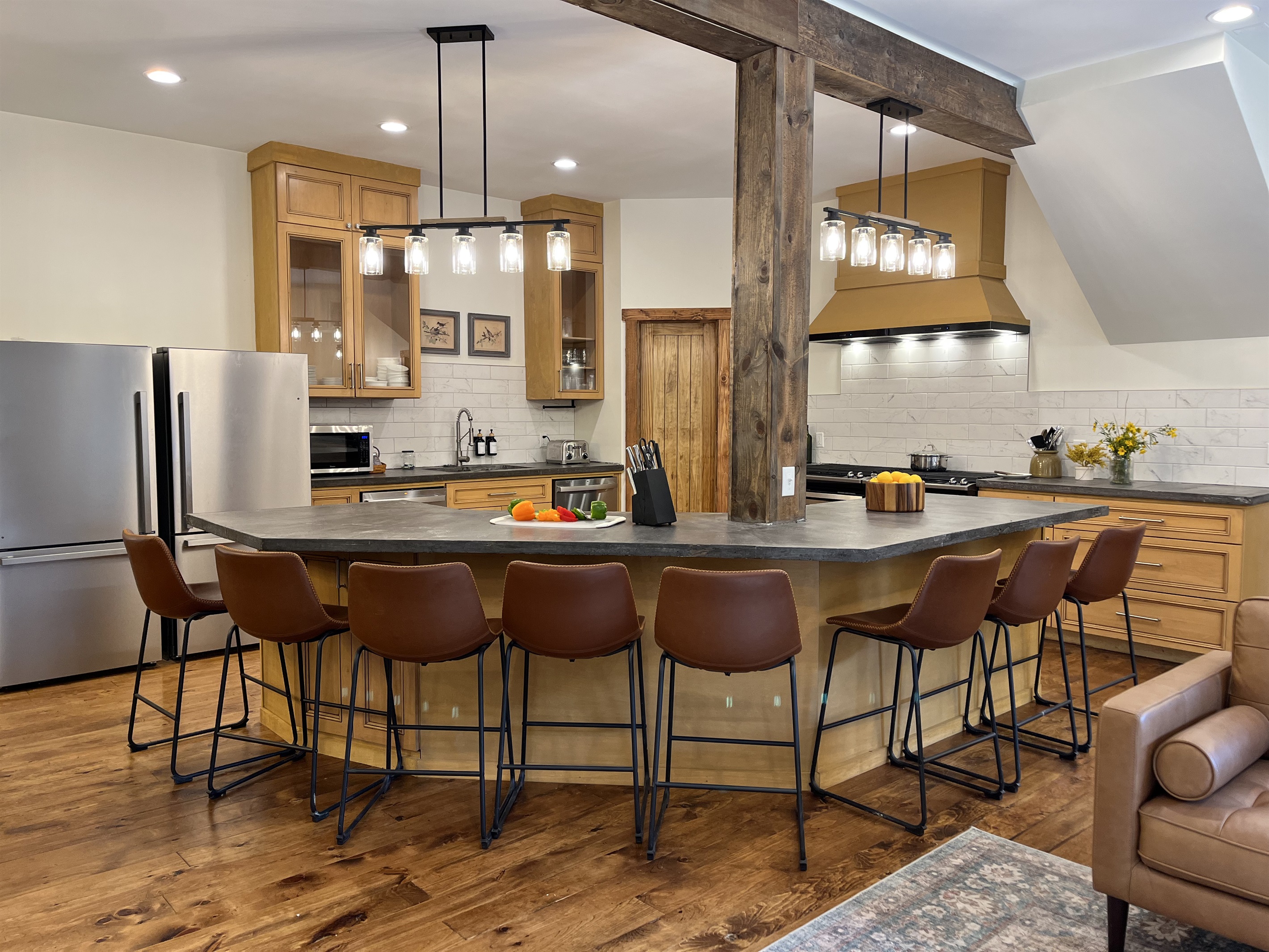 A kitchen built for crowds! Featuring an oversized 8-seat island, double ovens, two refrigerators, and two dishwashers to make group meals and cleanup effortless