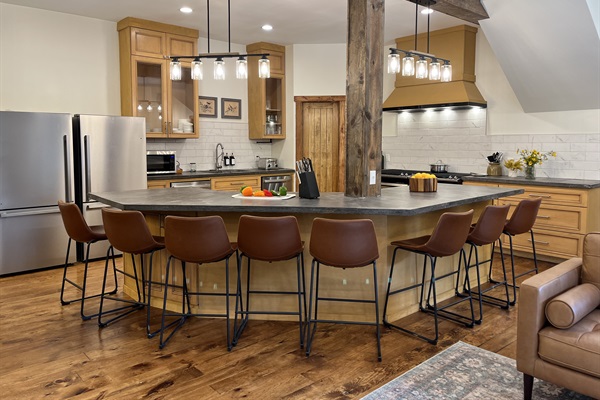 A kitchen built for crowds! Featuring an oversized 8-seat island, double ovens, two refrigerators, and two dishwashers to make group meals and cleanup effortless