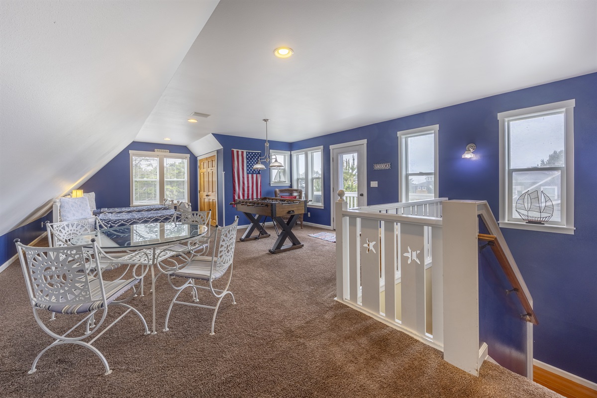 Fun-filled top-floor loft with twin beds, an air hockey and game table, plus a peek of the ocean from the deck and a refreshing coastal breeze.