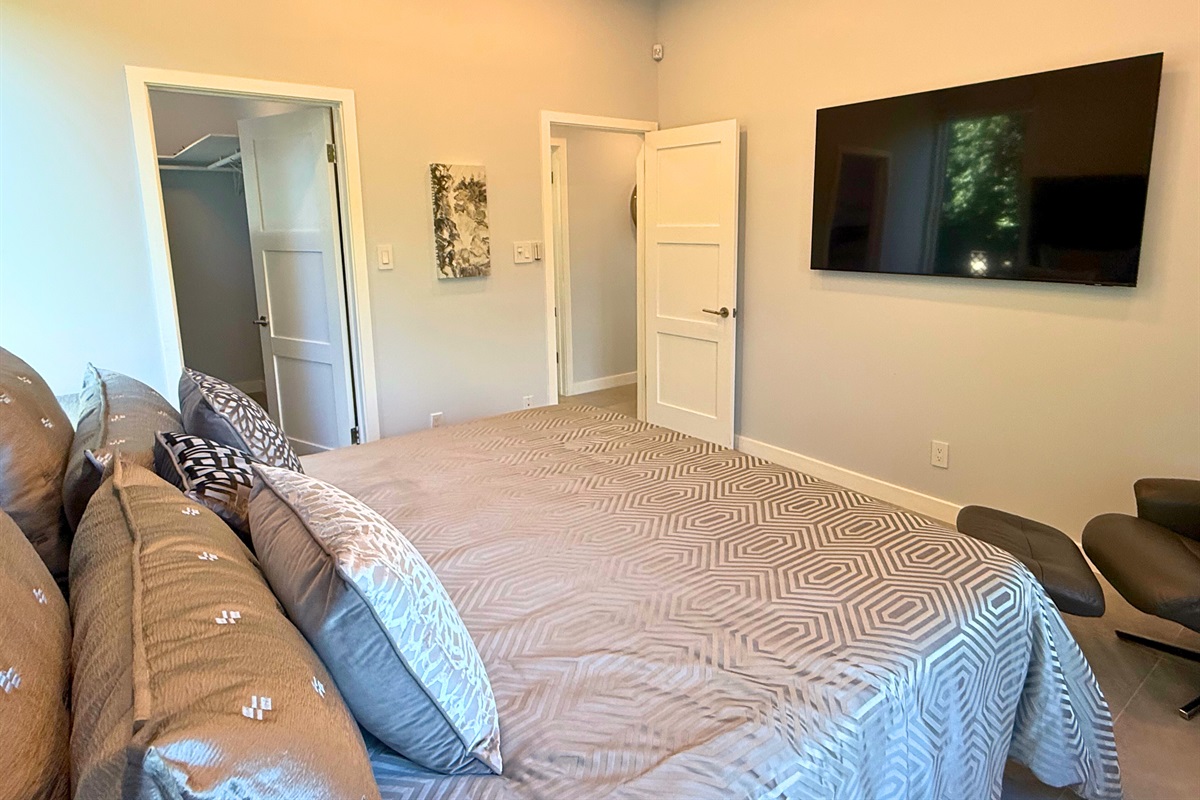 The second guest room on this floor has a king bed, ceiling fan and TV