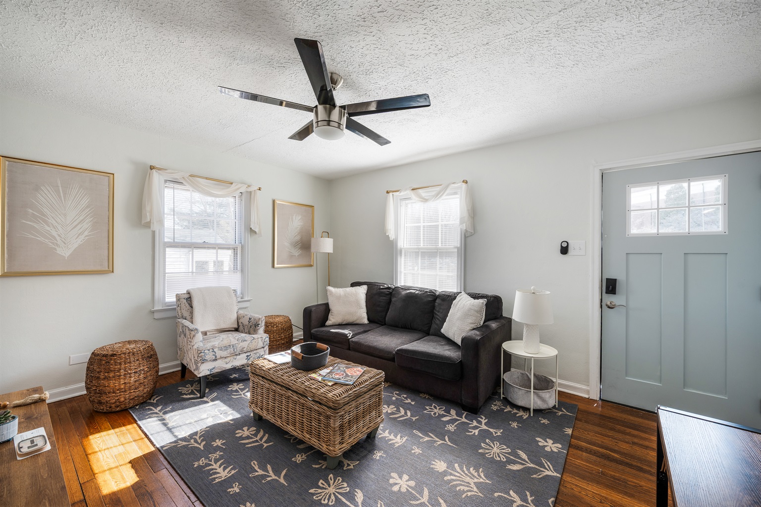 Open and comfortable living room with a queen pull-out sofa, additional seating, dining area, and TV with Xfinity Flex plus streaming apps.