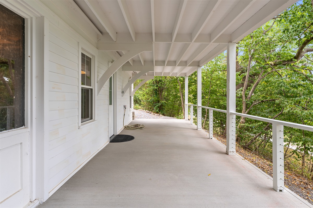 Spacious covered porch perfect for morning coffee or evening gatherings rain or shine.