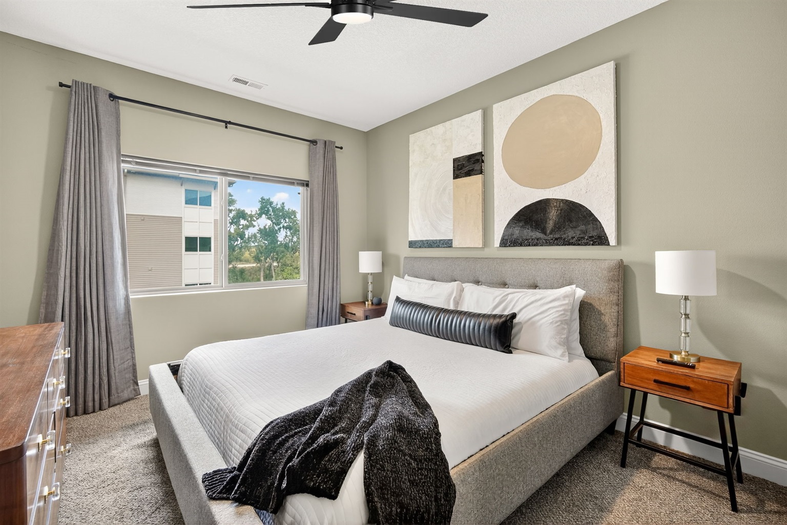 Relax in the primary bedroom with an ultra plush, Tempurpedic king-sized bed, plush bedding, and warm neutral palette.