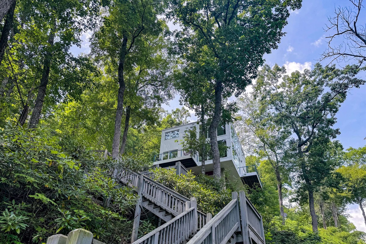 The upper staircase looking up at the house from halfway to the dock! You will love being engulfed in the rhododendron as you make your way along the staircase.