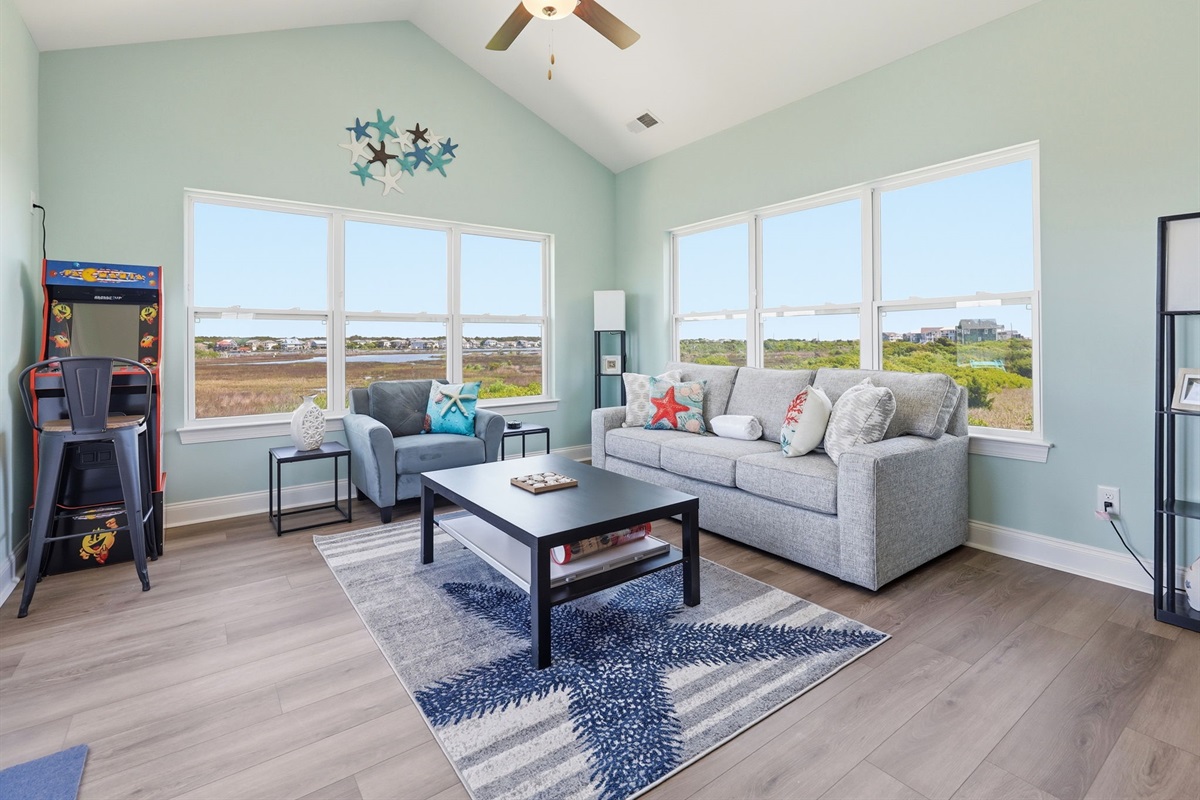 Coastal tones, natural light, and views that carry through the room