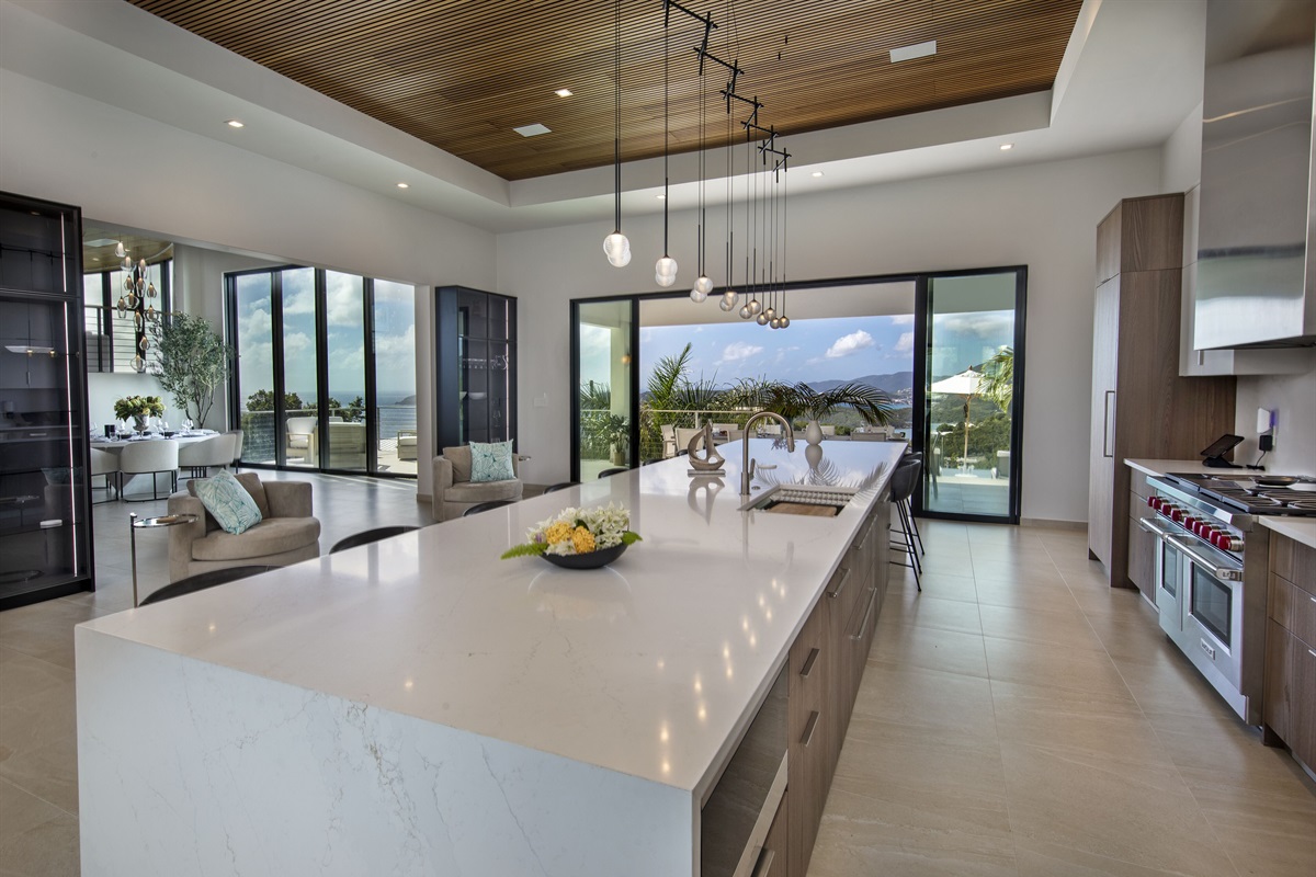 View from kitchen looking out to pool deck and dining area 