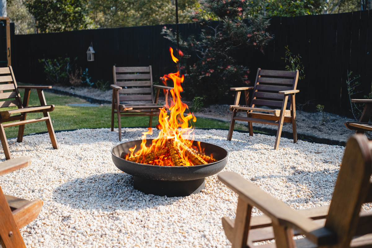 Room to relax, play and spend time together in this large backyard with fire pit seating and outdoor play equipment.