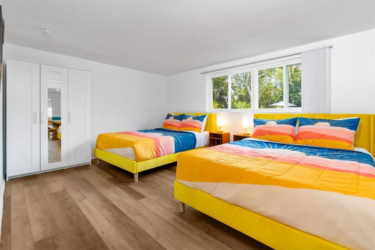 This bedroom has ample space even with 2 queen size beds. 