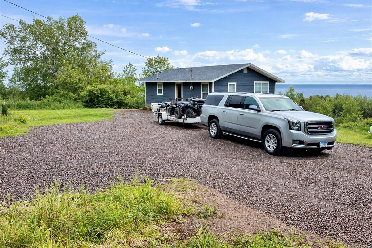 Spacious private parking with room for large vehicles, trucks, and trailers, perfect for ATV, snowmobile, and biking adventures. White Rock offers plenty of space to unload and gear up, with nearby trail access for year-round outdoor fun!