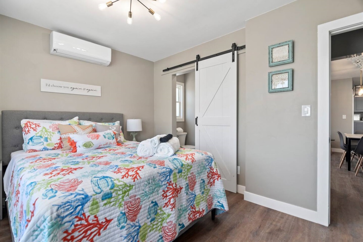 Primary bedroom with full bath. Plenty of light with darkening curtains, white noise machine, echo dot, so you could enjoy a nap in the middle of a busy beach town. 