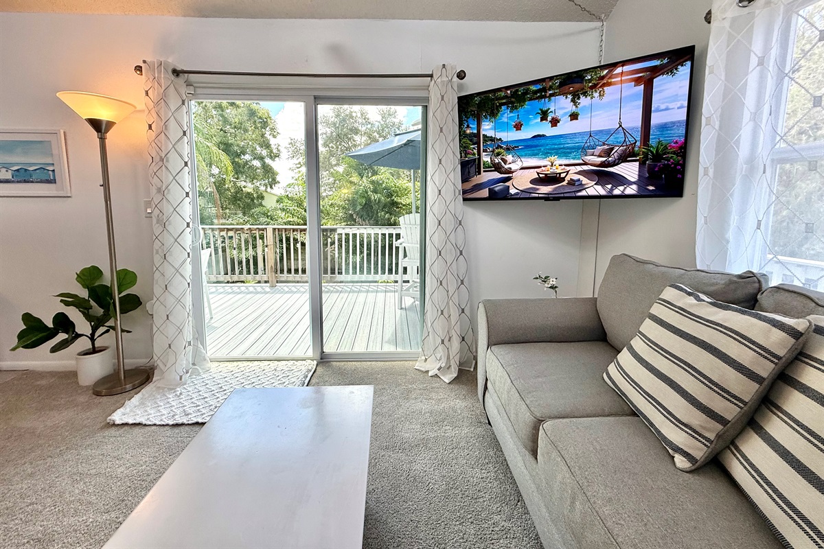 Natural light pours through the large windows, filling this open living room with warmth and creating a perfect space to relax with family and friends.
