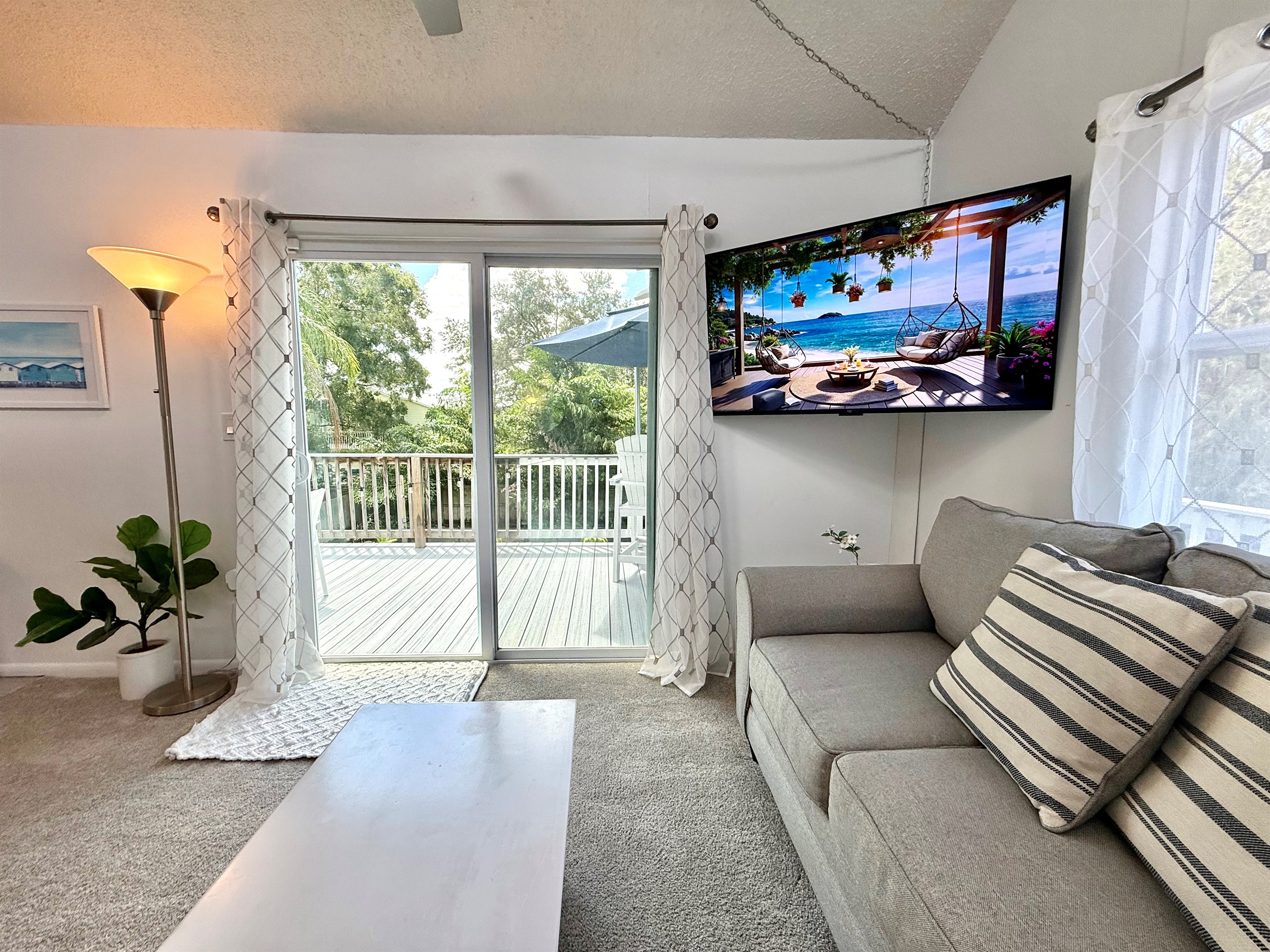 Natural light pours through the large windows, filling this open living room with warmth and creating a perfect space to relax with family and friends.