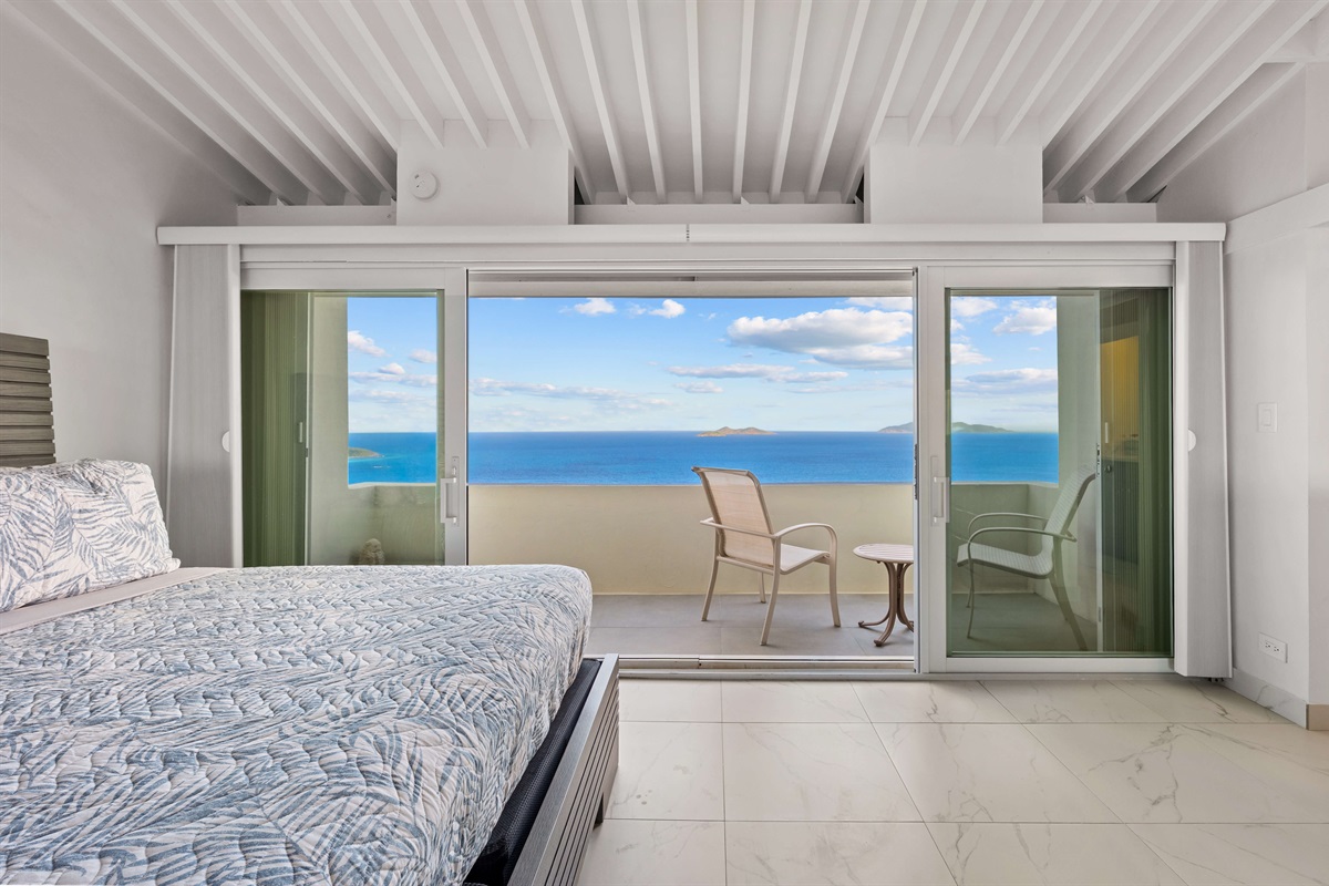 Primary king suite opens to a patio with seating