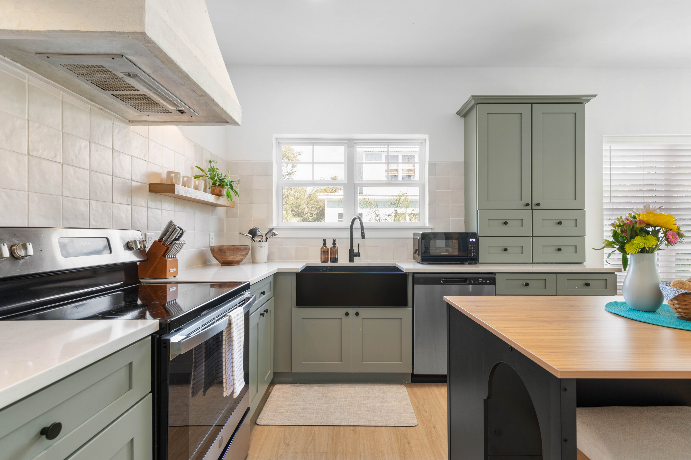 Counter space on both sides of the range, a dishwasher tucked in beside the sink, and a pantry tall enough for a full week of groceries. Cook a proper meal here without anyone having to leave the room.