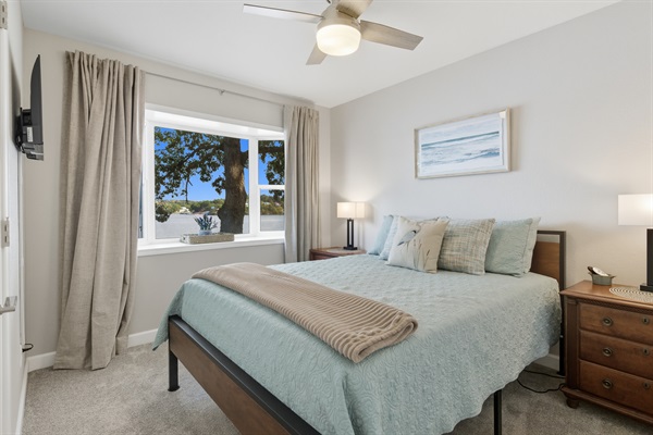 Comfortable queen bedroom with natural light and lake view