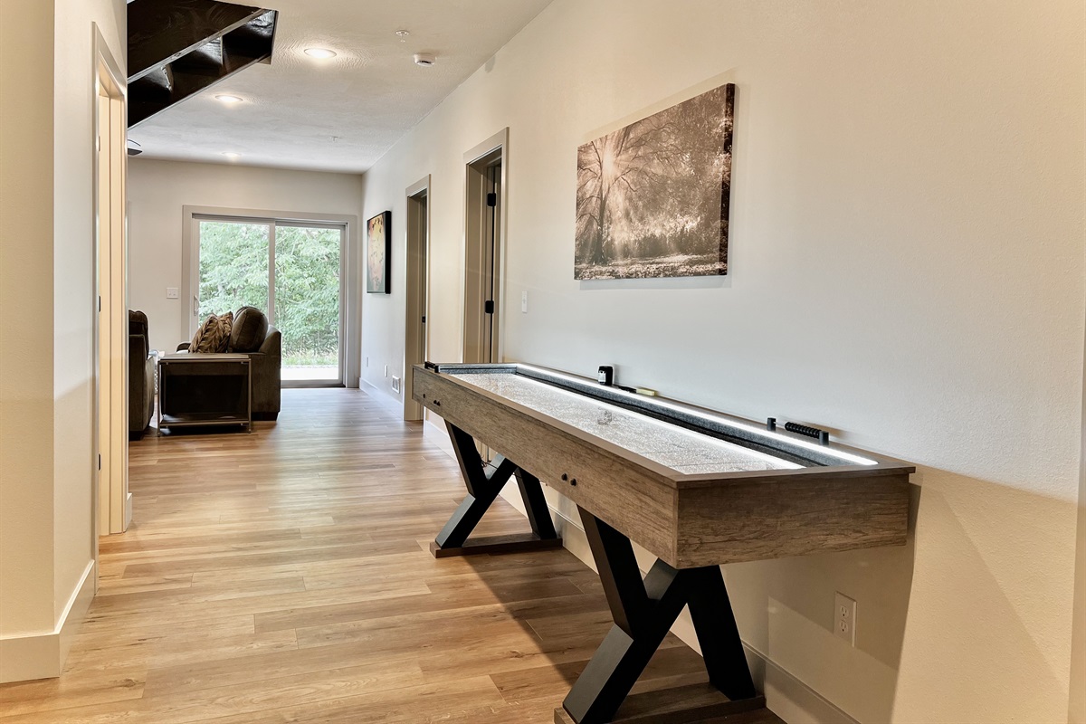 Shuffle board table located in the game room!