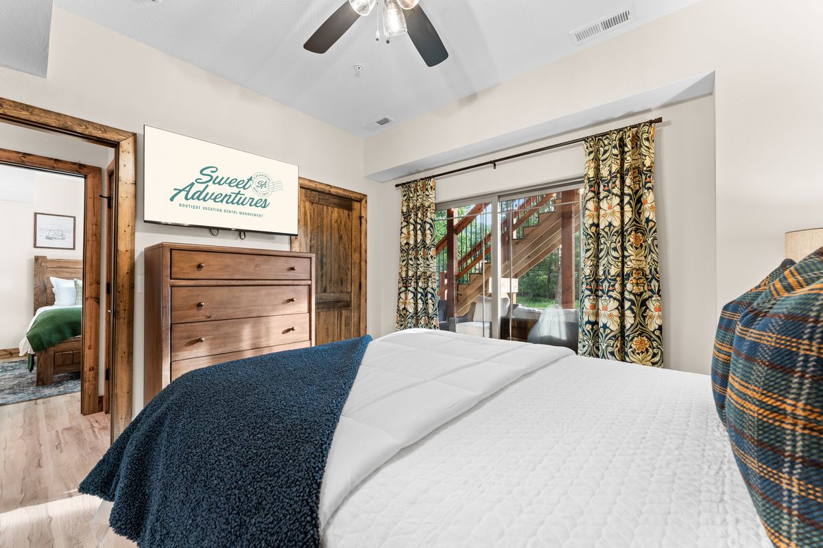 Smart TV, botanical curtains, and a walkout slider under the staircase greenery will have you dreaming of nature and adventure.