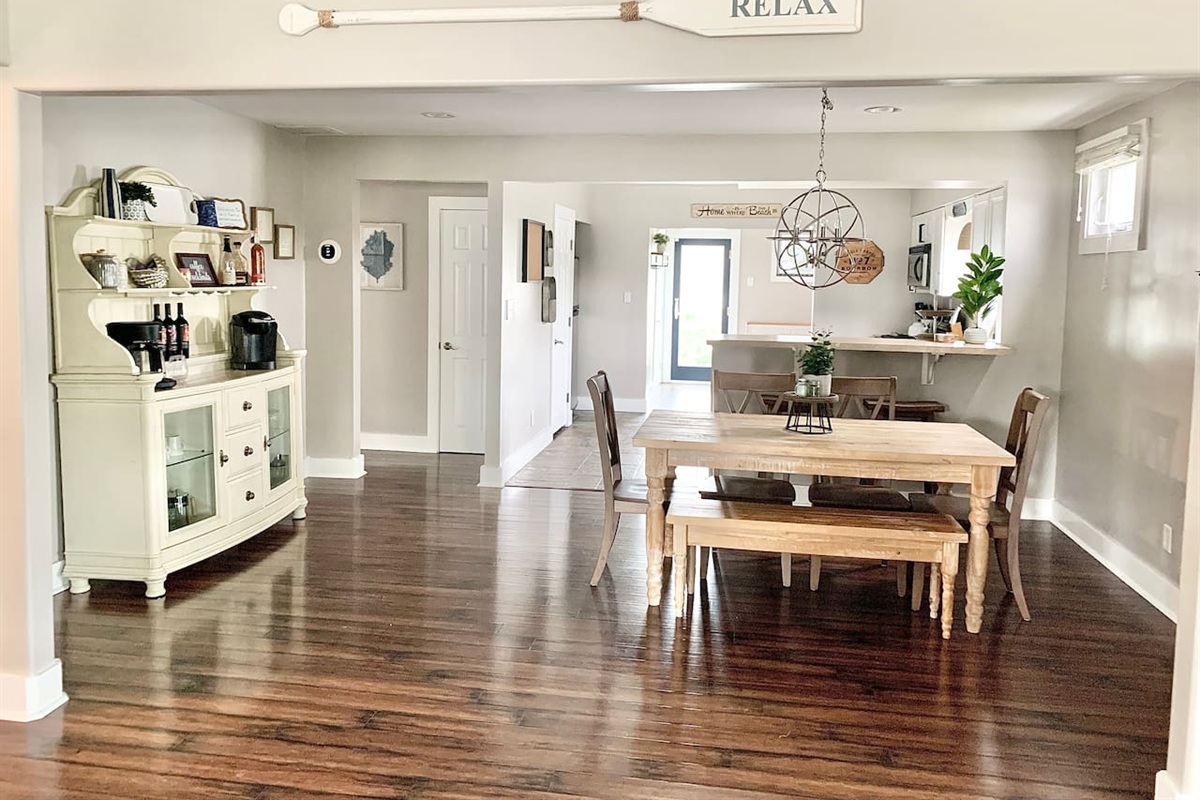 Gather for a meal or a morning coffee in this bright, open dining area. The space features a rustic wooden table with bench seating, a stylish bar area, and a dedicated coffee station to kickstart your vacation mornings.