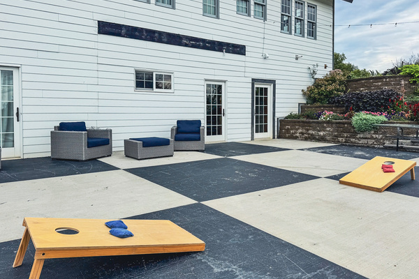 Patio with cornhole and outdoor seating.
