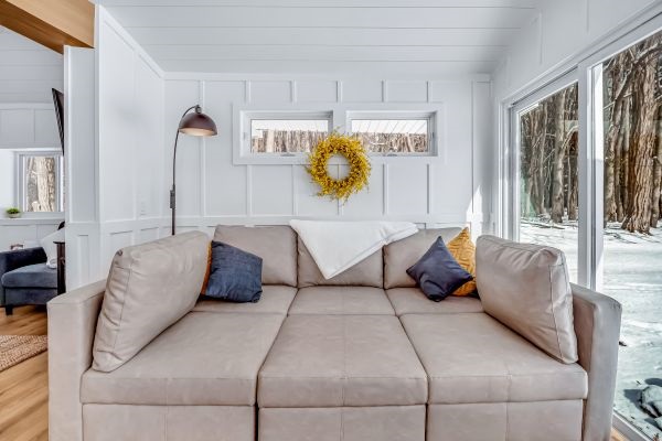 Warm and inviting, the living room offers comfortable seating. Perfect for relaxing by the window and enjoying snowy winter views.