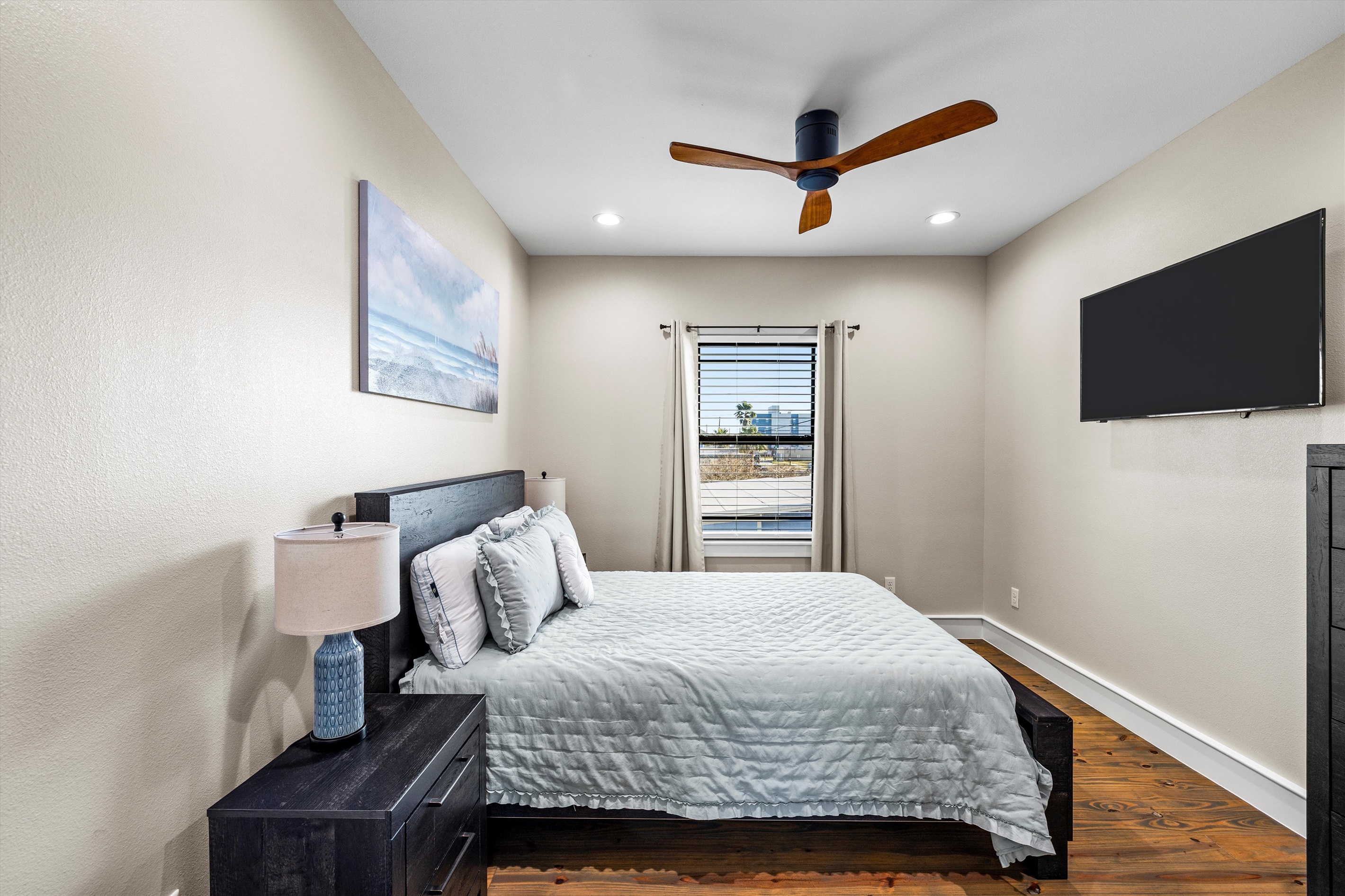 Guest Bedroom: Bright space with beachy vibes, stylish decor, and a view to unwind!