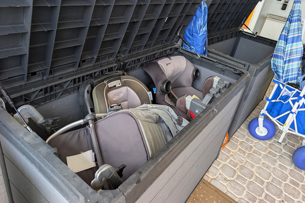 Heavy-duty outdoor storage boxes in the carport at Villa Coral protecting complimentary baby car seats, strollers, and beach wagons from the elements in Dorado, Puerto Rico.