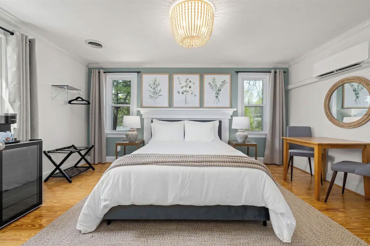 Eucalyptus Suite Bedroom #1 includes queen bed, dresser, TV, mini fridge & table