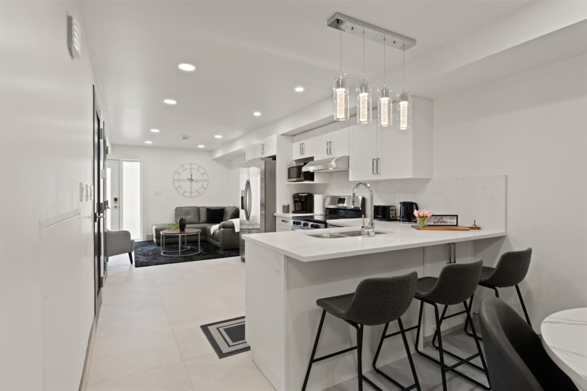 The open concept design takes advantage of creating a smooth transitions from the dining area to the kitchen with an eat-in counter top bar.